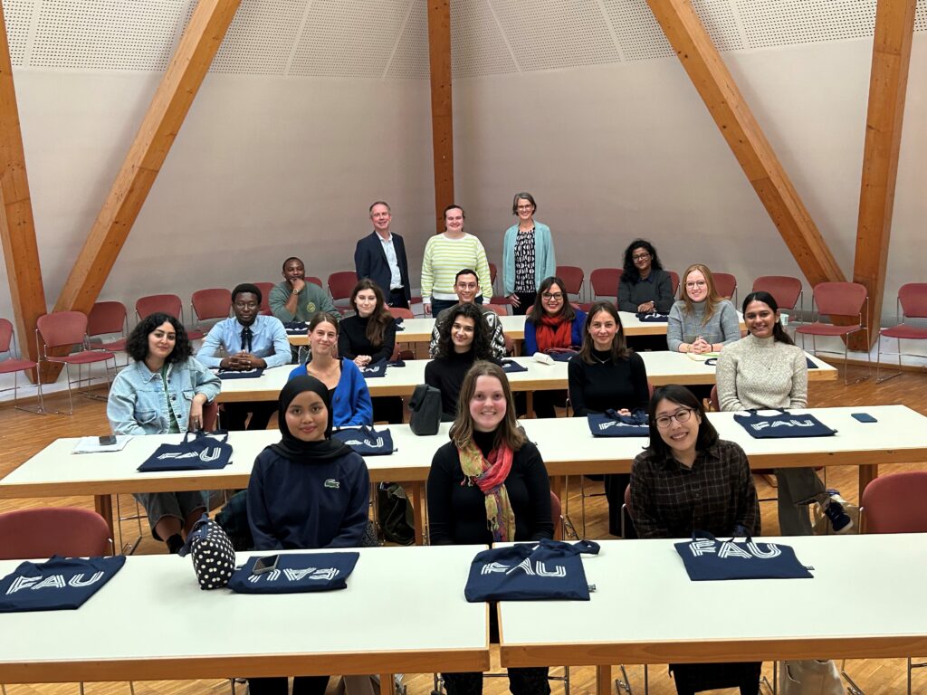 group photo of the new MA students sitting at tables with the program team standing behind them